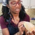 Shauna inspects a small loaf of bread made from scratch.